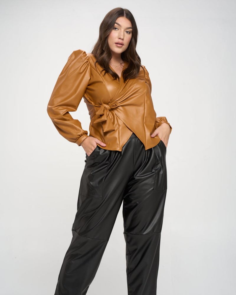 Front of a model wearing a size 3X Vegan Leather Wrap Top in Camel by L I V D. | dia_product_style_image_id:240185